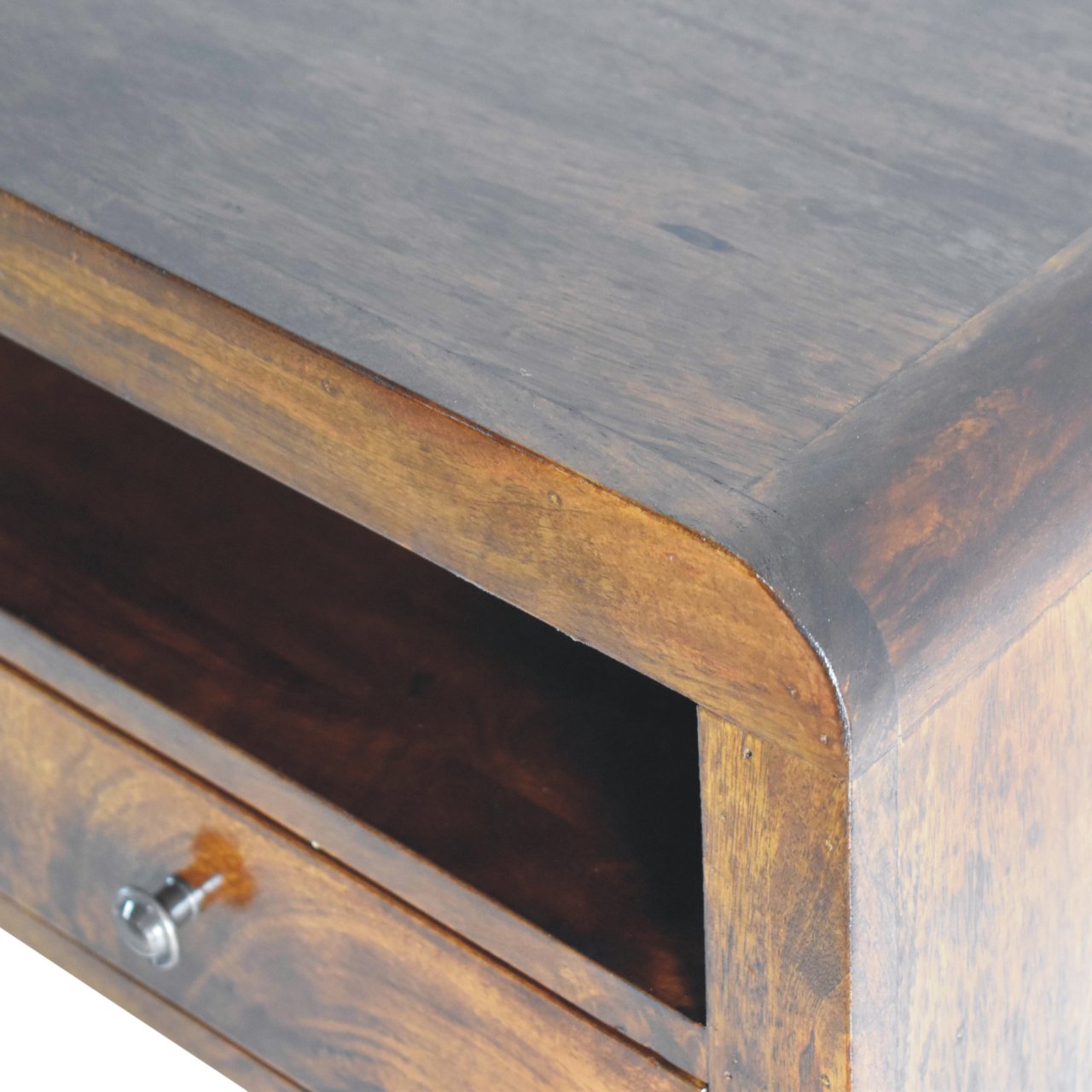 Chunky Wall Mounted Curved Chestnut Bedside Unit made from solid mango wood with one drawer and open shelf. Edge view