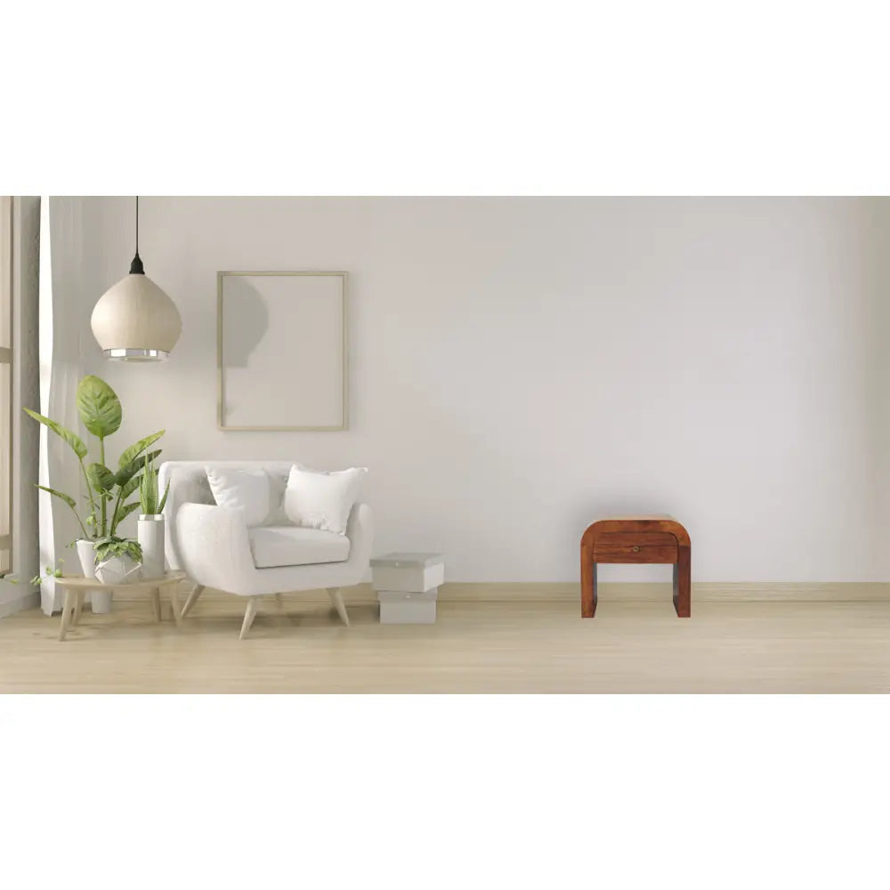 Darcy chestnut nightstand with curved edges and one drawer with brass knob. In a living room view