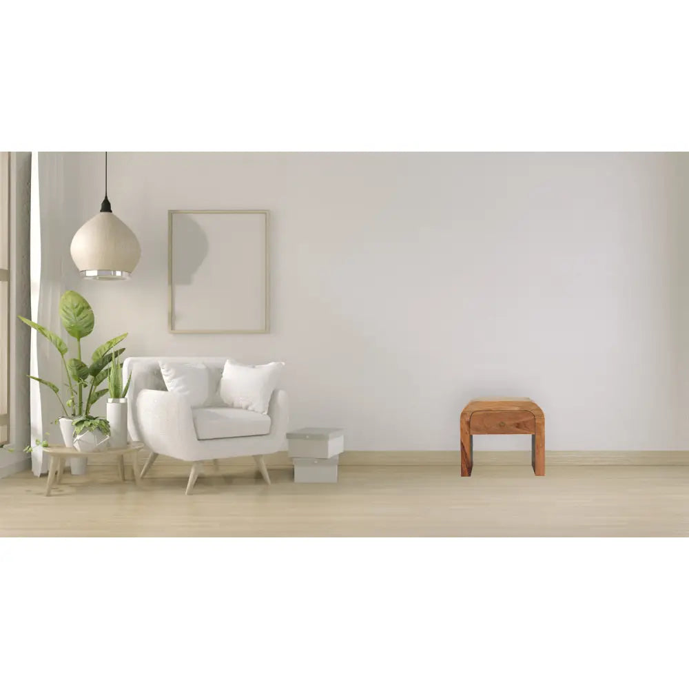 Darcy nightstand with one drawer, open shelf, brass knob, and solid mango wood frame in chestnut finish. Nightstand in a living space.