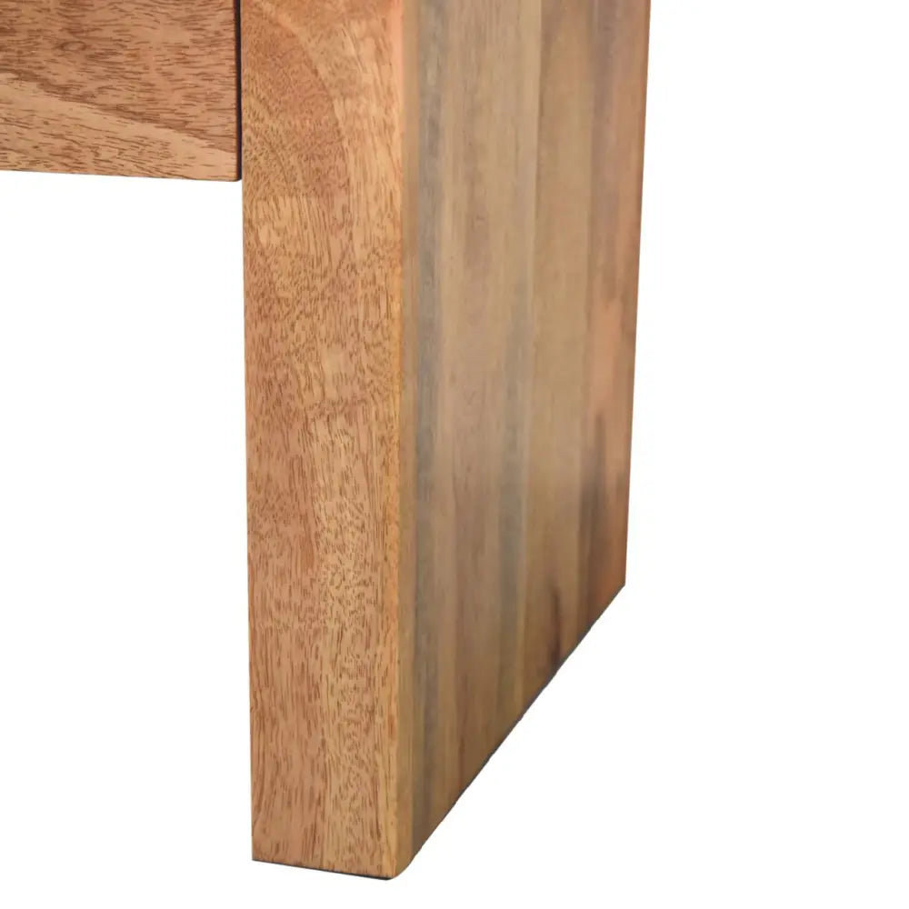 Darcy nightstand with one drawer, open shelf, brass knob, and solid mango wood frame in chestnut finish. Foot of nightstand.