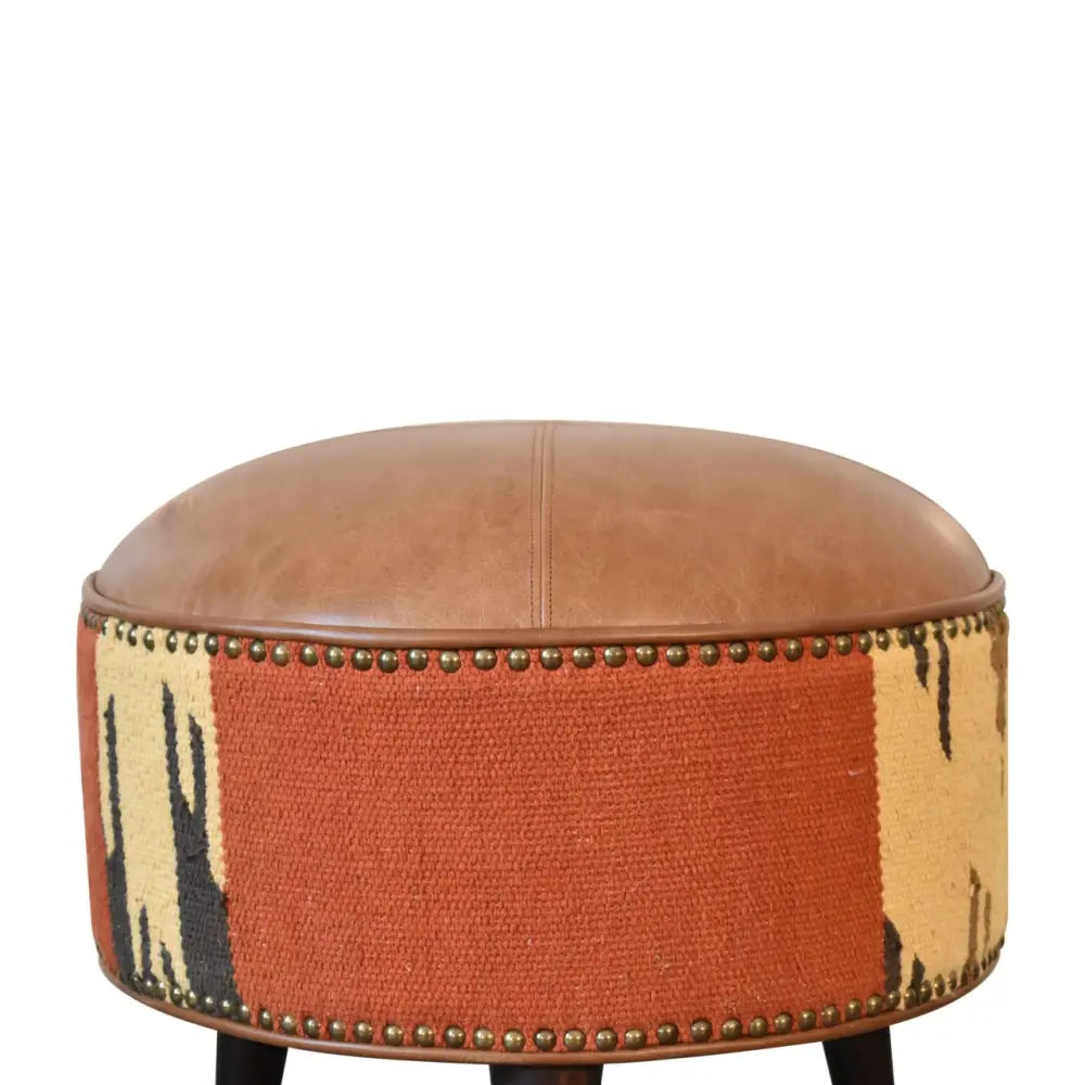 Durrie & Leather Mixed Footstool with Nordic-style legs, buffalo leather, and durrie print. close up view of print.
