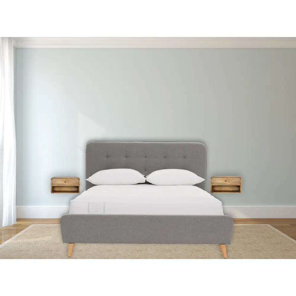 Floating Curve Open Slot Nightstand with one drawer and open shelf, made from solid mango wood. Two wall mounted nightstand by bedside.