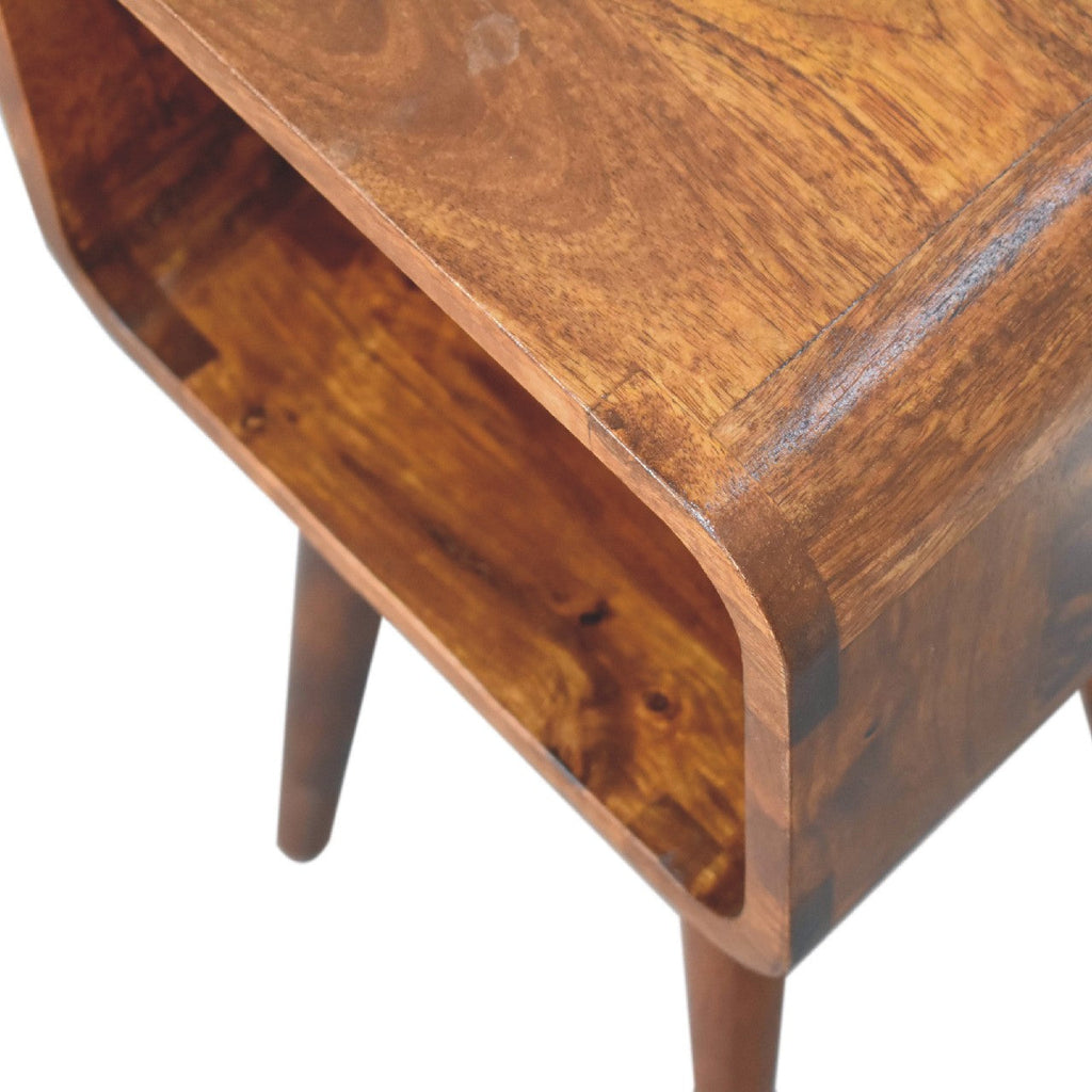 Mini Chestnut Open Nightstand made from solid mango wood with four tapered legs and one open storage compartment. smooth edge view