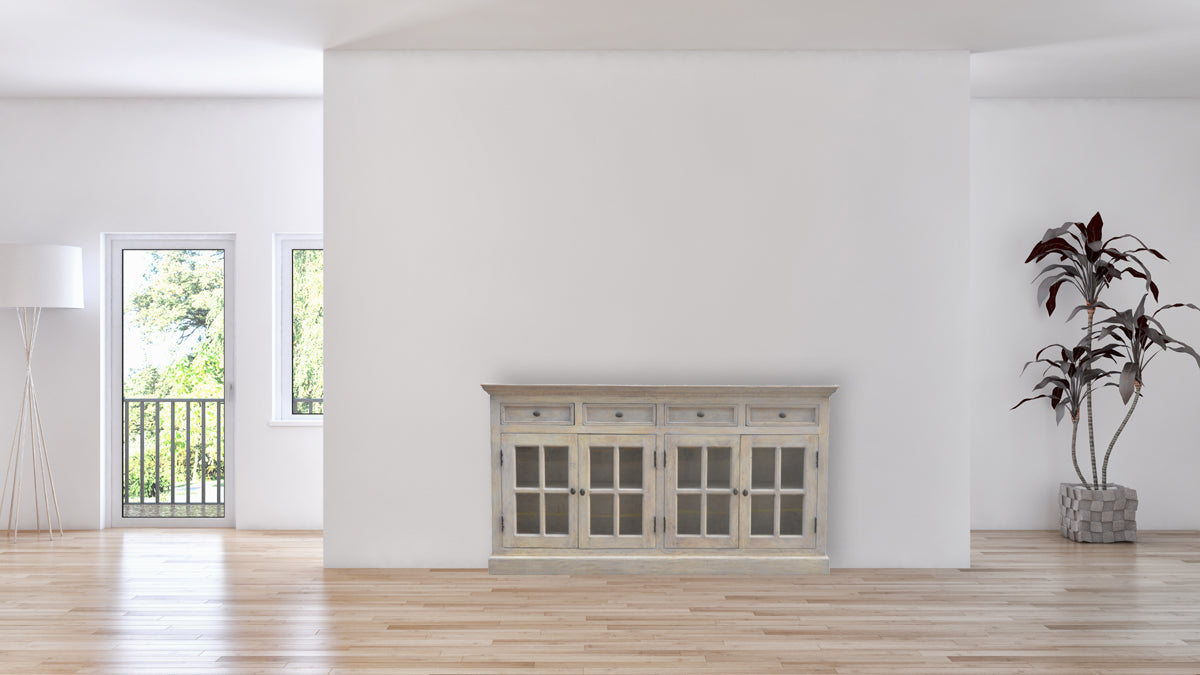 Stone Acid Wash Glazed Sideboard made from solid mango wood with four drawers and four glazed doors. Sideboard positioned on the wall of a living room
